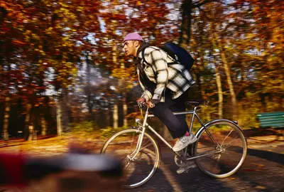 Cycling male, autumn trees on the background.
