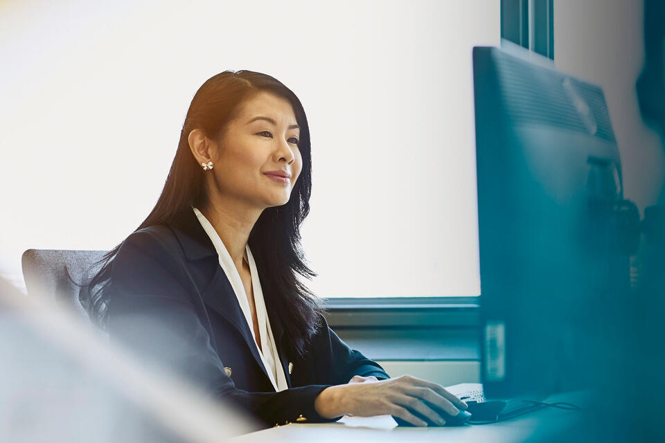 A woman working at her desk Randstad Professional Career